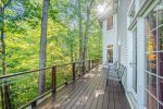 Sprawling deck on the backside of the house with views out over the ravine and trees